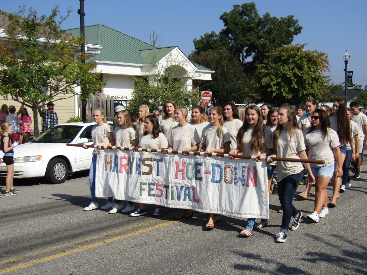 Group of women holding a festival banner